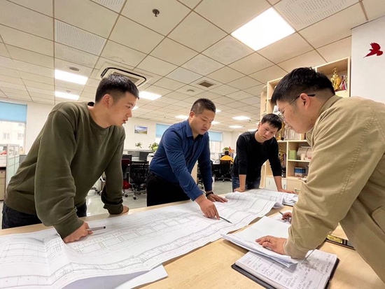 徐斌（左二）和同事在讨论设计方案。2024年10月摄于中铁第一勘察设计院。